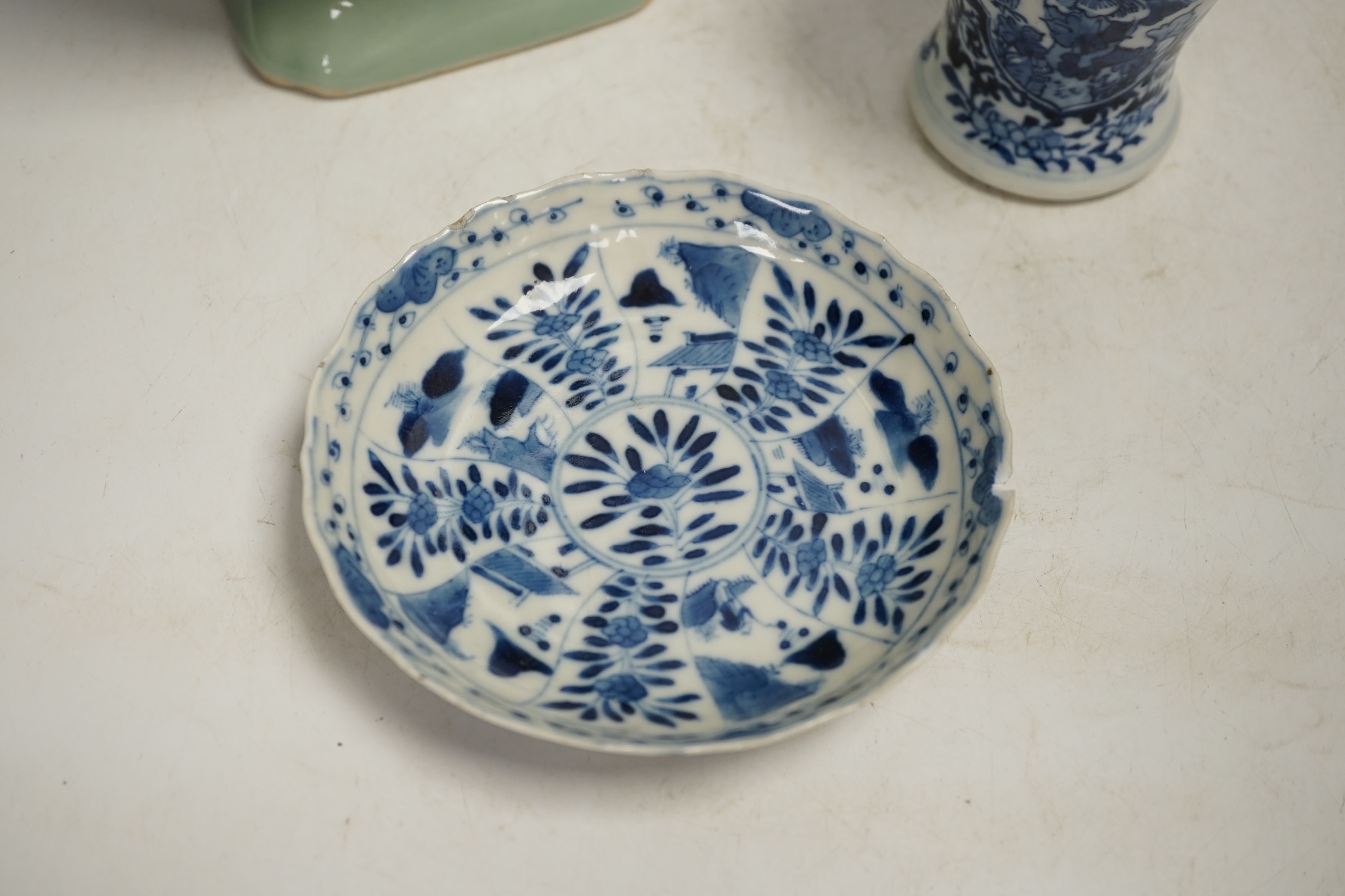 A Chinese celadon glazed two handled vase and a Chinese blue and white vase and dish, celadon vase 28.5cm high. Condition - celadon vase has a firing flaw and large crack, both blue and white vase are in damaged conditio